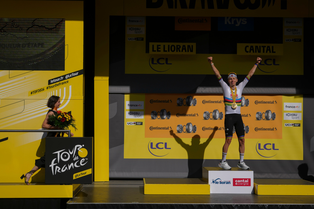 Slovenia's Tadej Pogacar celebrates on the podium after winning the tenth stage of the Tour de France cycling race with start in Aurillac and finish in Le Lioran, France, Tuesday, July 14, 2026. (AP Photo/Thibault Camus)