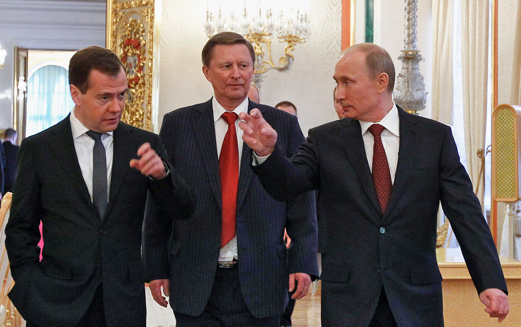 FILE - Russian Premier Dmitry Medvedev, left, Deputy Premier Sergei Ivanov, center, and Russian President Vladimir Putin walk after a state-of-the nation address in Moscow, Russia, Wednesday, Dec. 12, 2012. (AP Photo/Misha Japaridze, File)