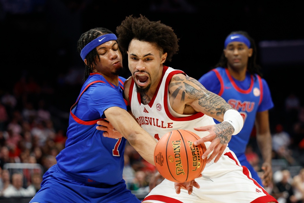Louisville guard J'vonne Hadley, right, drives into SMU forward Jermaine O'Neal Jr. during the first half of an NCAA college basketball game in the second round of the Atlantic Coast Conference tournament in Charlotte, N.C., Wednesday, March 11, 2026. (AP Photo/Nell Redmond)