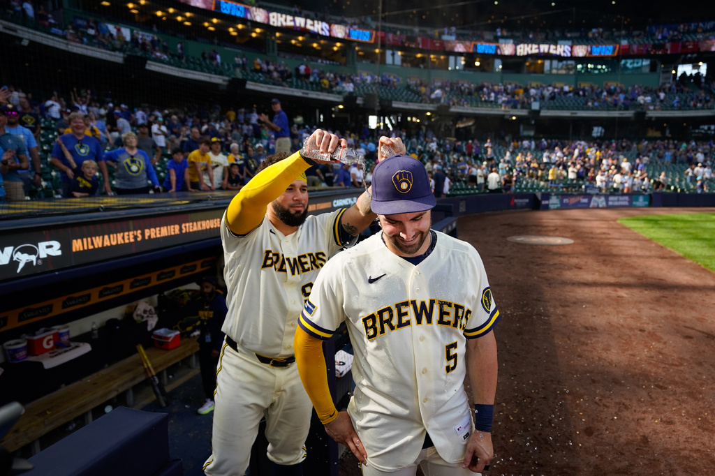 Milwaukee Brewers' Gary Sánchez, left, pours water on Garrett Mitchell (5) after winning a baseball game against the Seattle Mariners Thursday, Aug. 20, 2026, in Milwaukee. (AP Photo/Kayla Wolf)