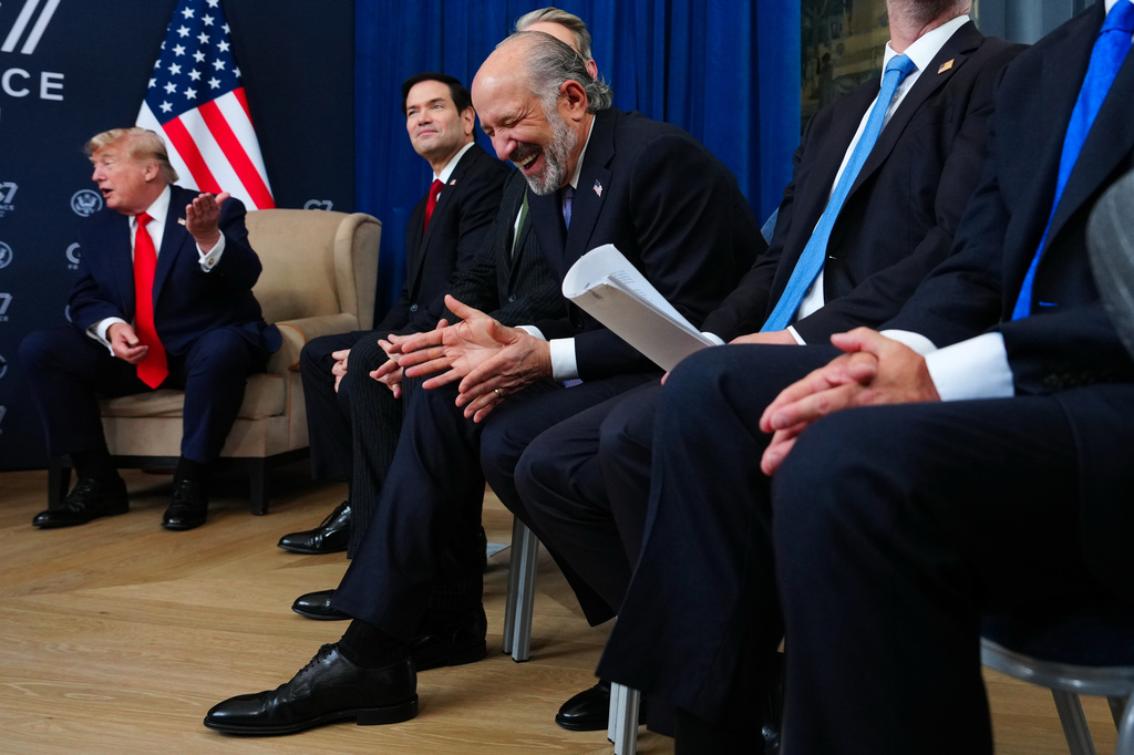Commerce Secretary Howard Lutnick laughs as President Donald Trump meets with Crown Prince of Abu Dhabi Sheikh Khaled Bin Mohamed Bin Zayed Al Nahyan on the sidelines of the G7 summit, Tuesday, June 16, 2026, in Evian-les-Bains, France. (AP Photo/Julia Demaree Nikhinson)