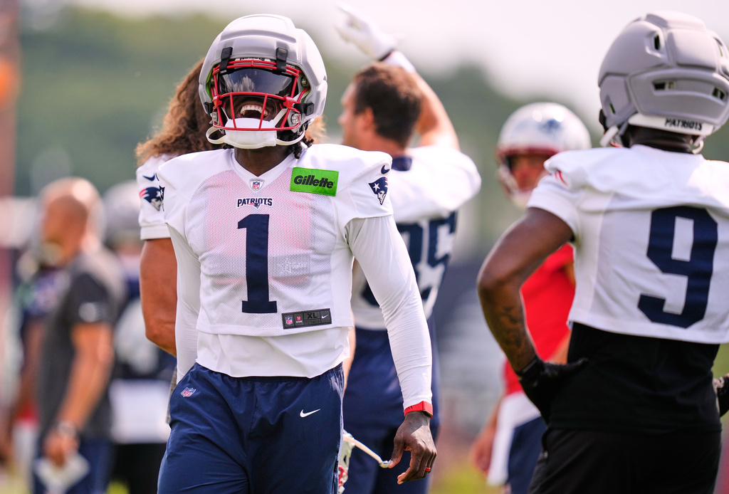 New England Patriots wide receiver A.J. Brown (1) laughs with teammates during the team's NFL football training camp, Tuesday, July 28, 2026, in Foxborough, Mass. (AP Photo/Charles Krupa)