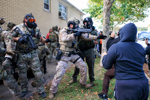Government officials push back protesters in Chicago, Tuesday, Oct. 14, 2025. (Anthony Vazquez/Chicago Sun-Times via AP) Government officials push back protesters in Chicago, Tuesday, Oct. 14, 2025. (Anthony Vazquez/Chicago Sun-Times via AP)