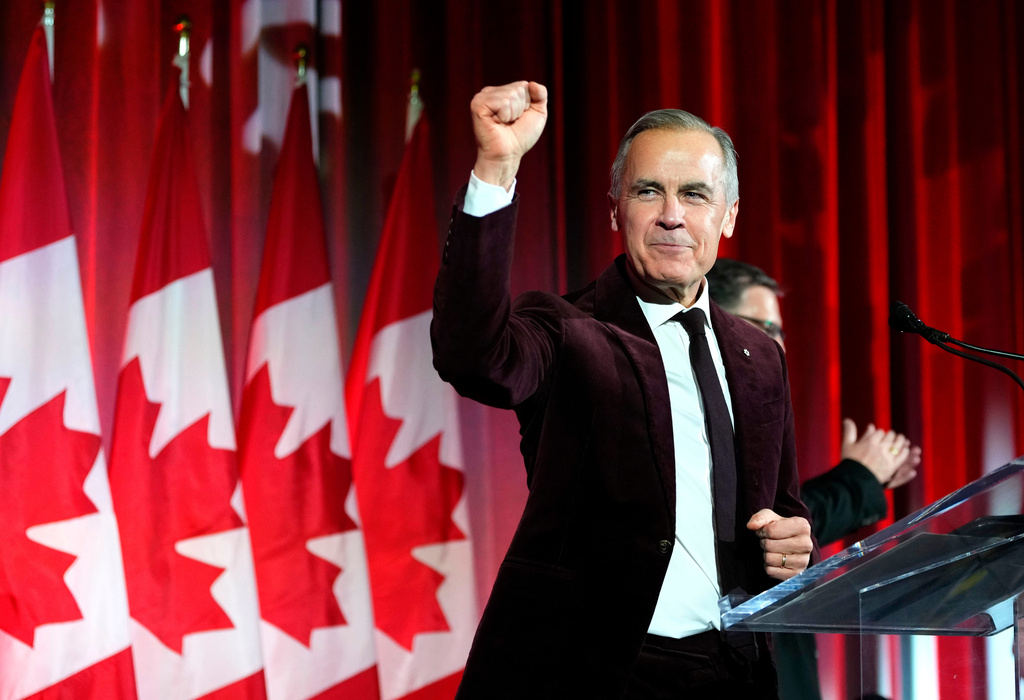 FILE - Canada's Prime Minister Mark Carney pumps his fist as he arrives to deliver remarks at the Liberal caucus holiday party in Ottawa, on Thursday, Dec. 11, 2025. (Justin Tang/The Canadian Press via AP, File)