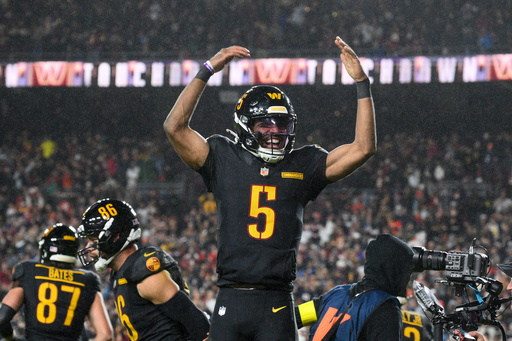Washington Commanders quarterback Jayden Daniels (5) celebrates a touchdown pass during the second half of an NFL football game against the Chicago Bears, Monday, Oct. 13, 2025, in Landover, Md. (AP Photo/Nick Wass) Washington Commanders quarterback Jayden Daniels (5) celebrates a touchdown pass during the second half of an NFL football game against the Chicago Bears, Monday, Oct. 13, 2025, in Landover, Md. (AP Photo/Nick Wass)