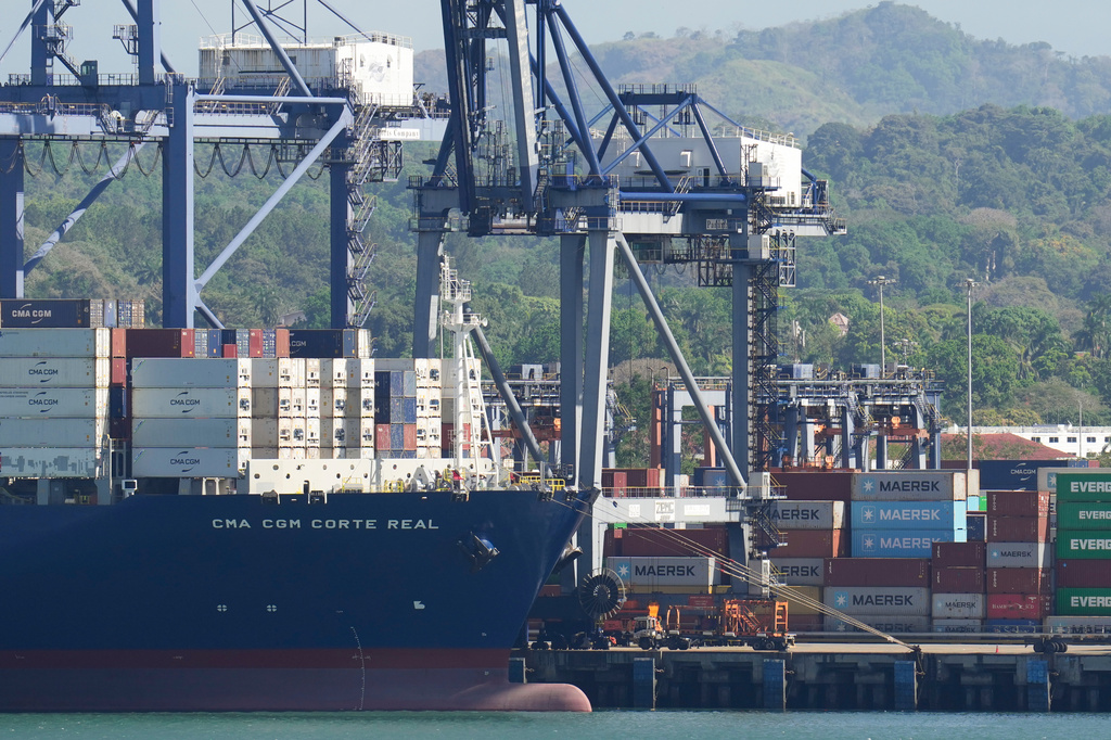 FILE - Cranes load a cargo ship at Panama Canal's Port of Balboa, managed by CK Hutchison Holdings, in Panama City, on Jan. 30, 2026. (AP Photo/Matias Delacroix, File)