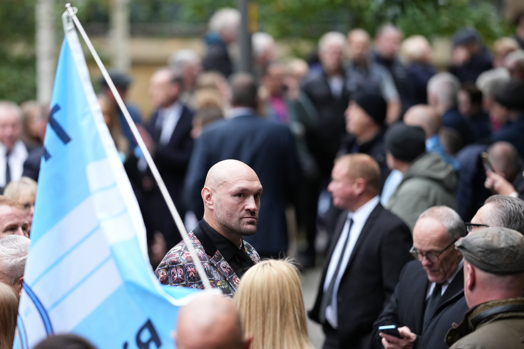 Boxer Tyson Fury, centre, attends the funeral of boxer Ricky Hatton, in Manchester, England, Friday, Oct. 10, 2025. (AP Photo/Jon Super)