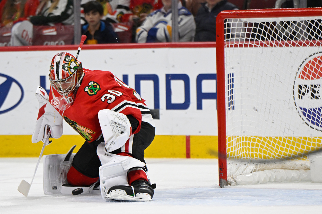 Chicago Blackhawks goalie Spencer Knight makes a save during the first period of an NHL hockey game against the Buffalo Sabres in Chicago, Monday, April 13, 2026. (AP Photo/Paul Beaty)