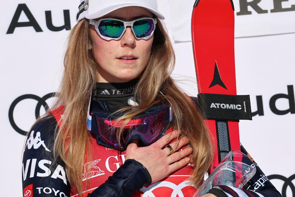 United States' Mikaela Shiffrin listens to the national anthem on the podium after winning an alpine ski, women's World Cup slalom, in Are, Sweden, Sunday, March 15, 2026. (AP Photo/Marco Trovati)