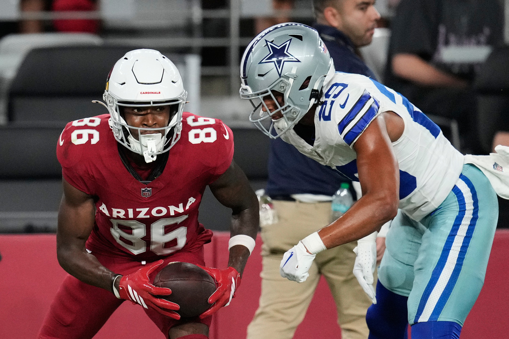 Arizona Cardinals wide receiver Jalen Brooks (86) celebrates his catch in front of Dallas Cowboys cornerback Devin Moore (29) in the first half of a preseason NFL football game Saturday, Aug. 22, 2026, in Glendale, Ariz. (AP Photo/Ross D. Franklin)