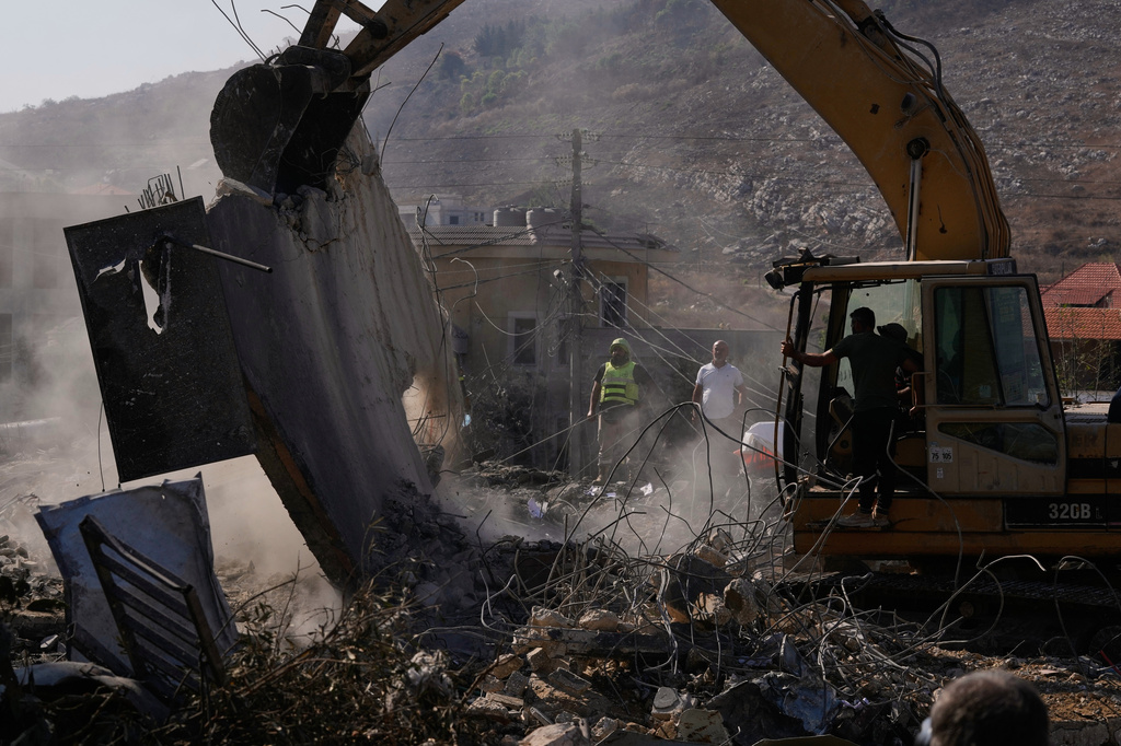 Rescue workers search for victims under the rubble of a building destroyed in an Israeli airstrike in the southern village of Kfar Rumman, Lebanon, Monday, Sept. 7, 2026. (AP Photo/Mohammed Zaatari)