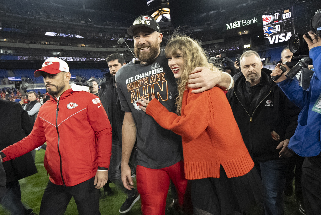 FILE - Kansas City Chiefs tight end Travis Kelce and Taylor Swift walk together after an AFC Championship NFL football game between the Chiefs and the Baltimore Ravens, Jan. 28, 2024, in Baltimore. (AP Photo/Julio Cortez, File)