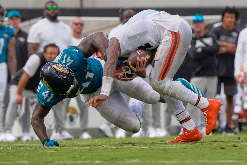 Cleveland Browns quarterback Deshaun Watson, right, is sacked by Jacksonville Jaguars defensive end Josh Hines-Allen (41) in the second half of an NFL football game, Sunday, Sept. 13, 2026, in Jacksonville. (AP Photo/Mike Stewart)