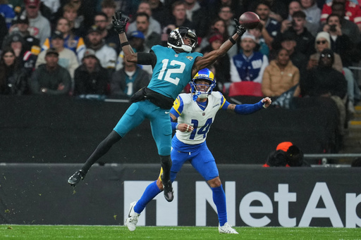 Jacksonville Jaguars wide receiver Travis Hunter (12) reaches to catch the ball as Los Angeles Rams cornerback Cobie Durant (14) challenges during the first half of an NFL football game between the Los Angeles Rams and the Jacksonville Jaguars in London, Sunday, Oct. 19, 2025. (AP Photo/Kin Cheung) Jacksonville Jaguars wide receiver Travis Hunter (12) reaches to catch the ball as Los Angeles Rams cornerback Cobie Durant (14) challenges during the first half of an NFL football game between the Los Angeles Rams and the Jacksonville Jaguars in London, Sunday, Oct. 19, 2025. (AP Photo/Kin Cheung)