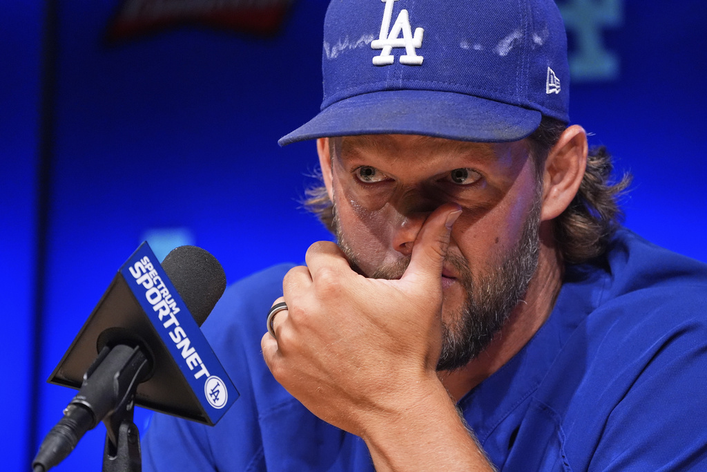 Los Angeles Dodgers pitcher Clayton Kershaw wipes his face as he speaks to the media after announcing his retirement at the end of the season prior to a baseball game against the Philadelphia Phillies Thursday, Sept. 18, 2025, in Los Angeles. (AP Photo/Mark J. Terrill)