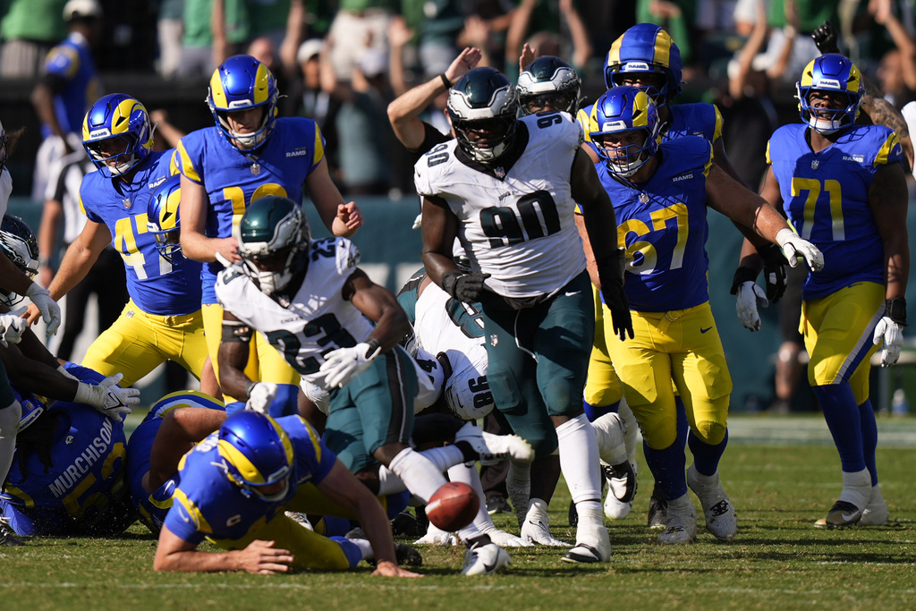 Philadelphia Eagles defensive tackle Jordan Davis (90) blocks a field goal attempt by Los Angeles Rams kicker Joshua Karty (16) before running the ball back for a touchdown as time expires during the second half of an NFL football game against the Los Angeles Rams Sunday, Sept. 21, 2025, in Philadelphia. (AP Photo/Chris Szagola)