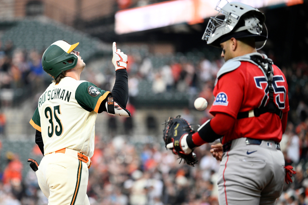 Baltimore Orioles' Adley Rutschman (35) celebrates after his two-run home run next to Boston Red Sox catcher Carlos Narváez (75) during the first inning of a baseball game, Friday, April 24, 2026, in Baltimore. (AP Photo/Nick Wass)