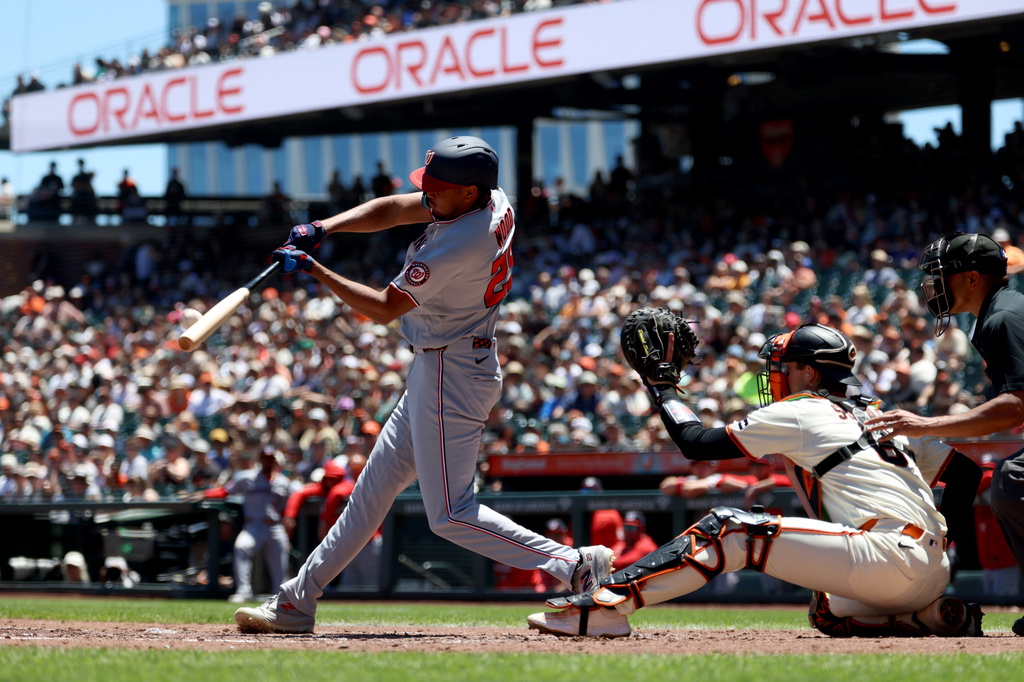 Washington Nationals' James Wood, left, hits a two-run home run in front of San Francisco Giants catcher Daniel Susac, right, during the third inning of a baseball game in San Francisco, Wednesday, June 10, 2026. (AP Photo/Jed Jacobsohn)
