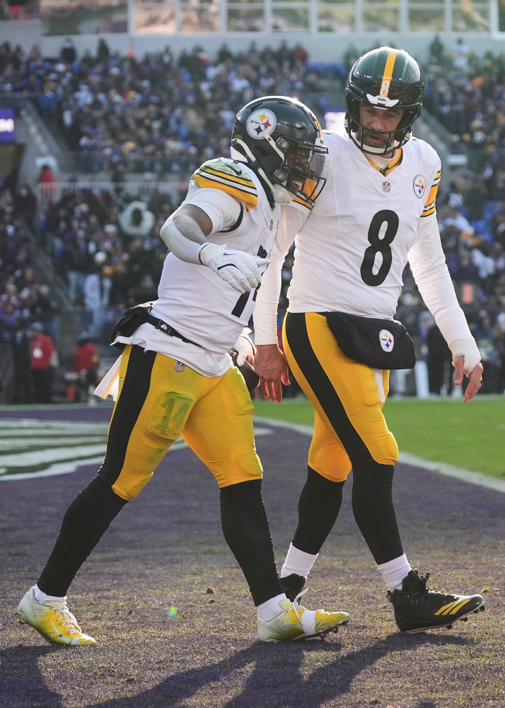 Pittsburgh Steelers running back Kenneth Gainwell (14) celebrates with quarterback Aaron Rodgers (8) after a touchdown during the first half of an NFL football game against the Baltimore Ravens, Sunday, Dec. 7, 2025, in Baltimore. (AP Photo/Stephanie Scarbrough)