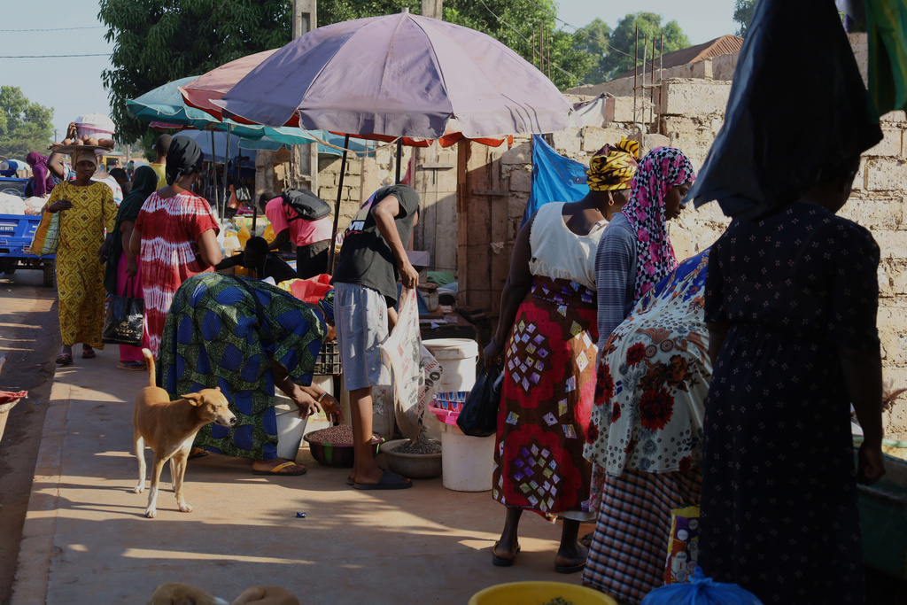 People sells goods at a market in Bissau, Guinea-Bissau, Friday, Nov. 28, 2025. (AP Photo/Darcicio Barbosa)