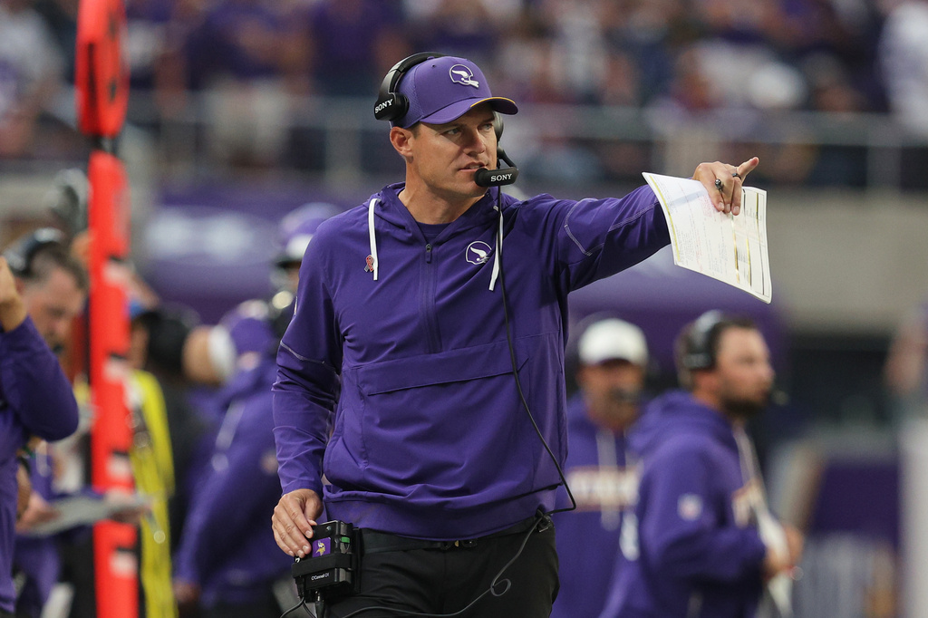 Minnesota Vikings head coach Kevin O'Connell talks on his headset as he watches play against the Green Bay Packers during the second half of an NFL football game, Sunday, Sept. 13, 2026, in Minneapolis, Minn. (AP Photo/Bailey Hillesheim)