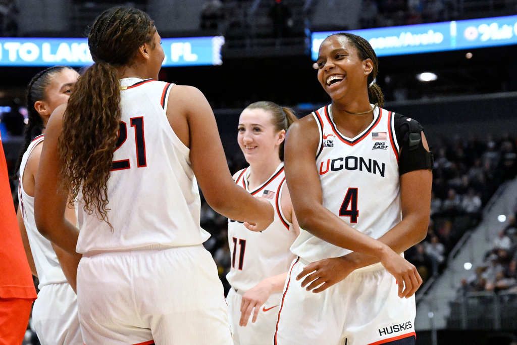 UConn guard Blanca Quinonez (4) celebrates with UConn forward Sarah Strong (21) in the second half of an NCAA college basketball game against Ohio State, Sunday, Nov. 16, 2025, in Hartford, Conn. (AP Photo/Jessica Hill)