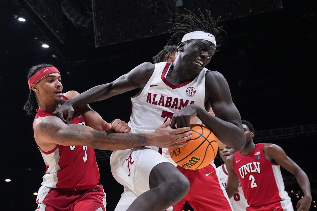 Alabama forward Taylor Bol Bowen (7) grabs a rebound in front of UNLV guard Howie Fleming Jr. (3) during the second half of an NCAA college basketball game in the Players Era tournament Las Vegas, Tuesday, Nov. 25, 2025. (AP Photo/Eric Gay)