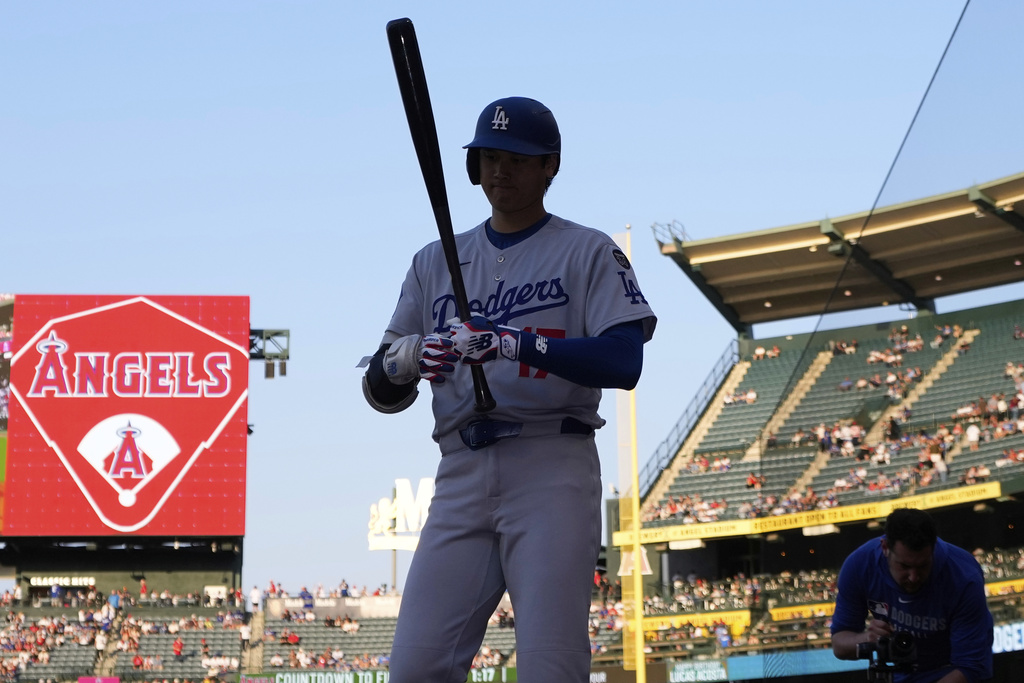 Los Angeles Dodgers' Shohei Ohtani stands in the on-deck circle during the first inning of a baseball game against the Los Angeles Angels, Tuesday, Aug. 12, 2025, in Anaheim, Calif. (AP Photo/Mark J. Terrill)