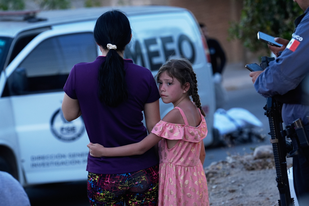 FILE - Relatives of a victim of a fatal armed attack look on as forensic workers investigate the scene, in Culiacán, Sinaloa state, Mexico, April 26, 2026. (AP Photo/Marco Ugarte, File)