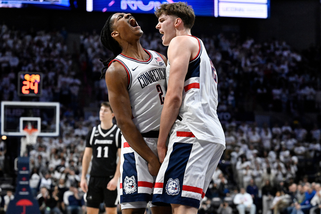 UConn guard Silas Demary Jr., left, and UConn center Eric Reibe, right, react in the first half of an NCAA college basketball game against Providence, Tuesday, Jan. 27, 2026, in Storrs, Conn. (AP Photo/Jessica Hill)