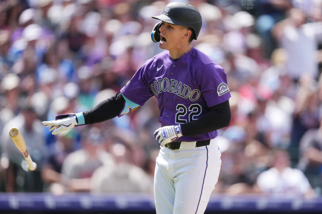 Colorado Rockies' Mickey Moniak tosses his bat as he heads up the first-base line after hitting a two-run home run off Atlanta Braves relief pitcher Aaron Bummer in the fourth inning of a baseball game, Sunday, May 3, 2026, in Denver. (AP Photo/David Zalubowski)