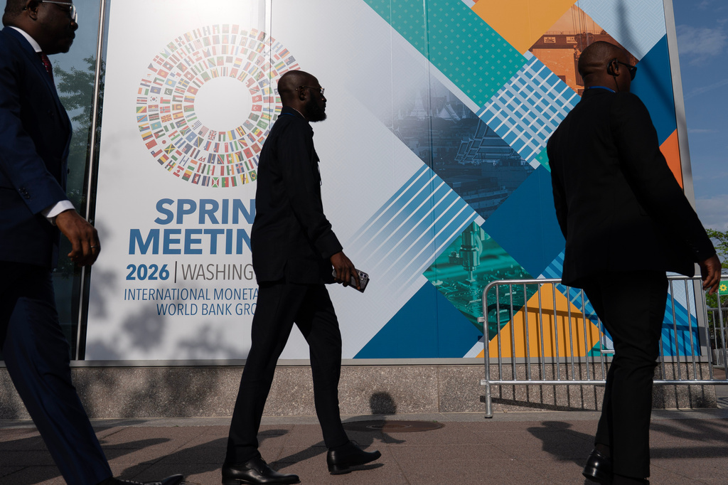 FILE - Delegates walk to the entrance of the International Monetary Fund (IMF) headquarters during the World Bank/IMF Spring Meetings at the IMF headquarters in Washington, April 15, 2026. (AP Photo/Jose Luis Magana, File)
