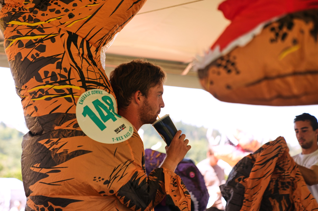 Jaymen Parker keeps hydrated before running in the T-Rex World Championship Races at Emerald Downs, Sunday, July 12, 2026, in Auburn, Wash. (AP Photo/Lindsey Wasson)