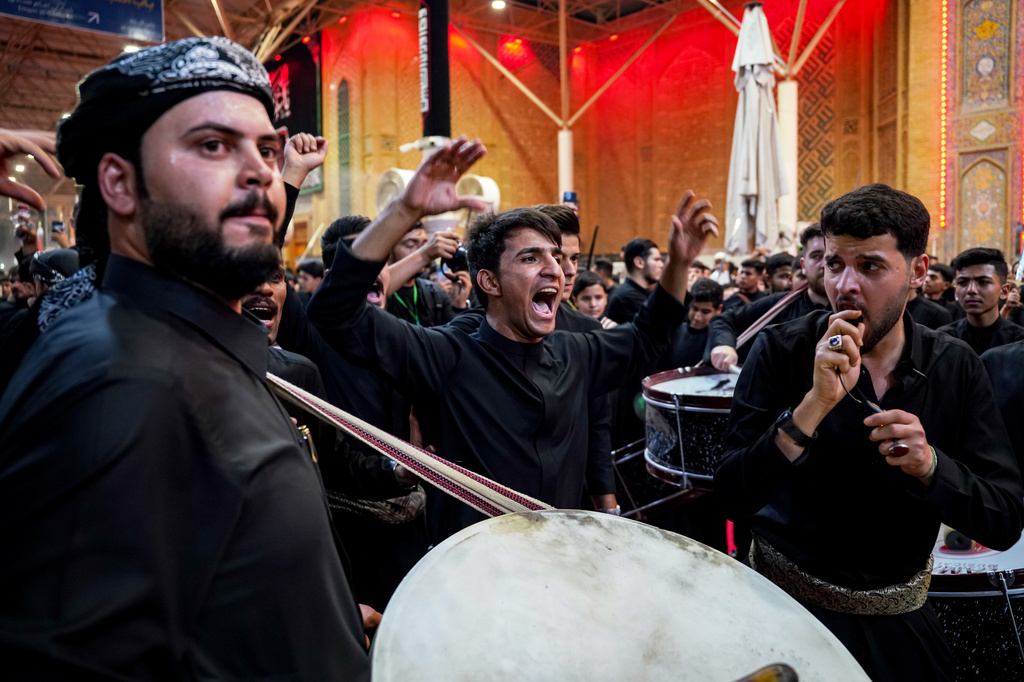 Shiites participate in Muharram processions of the Imam Ali shrine in Najaf, Iraq, Sunday, June 21, 2026, to mark the death of Hussein, the grandson of the Prophet Muhammad in present-day Iraq in the 7th century. (AP Photo/Anmar Khalil)