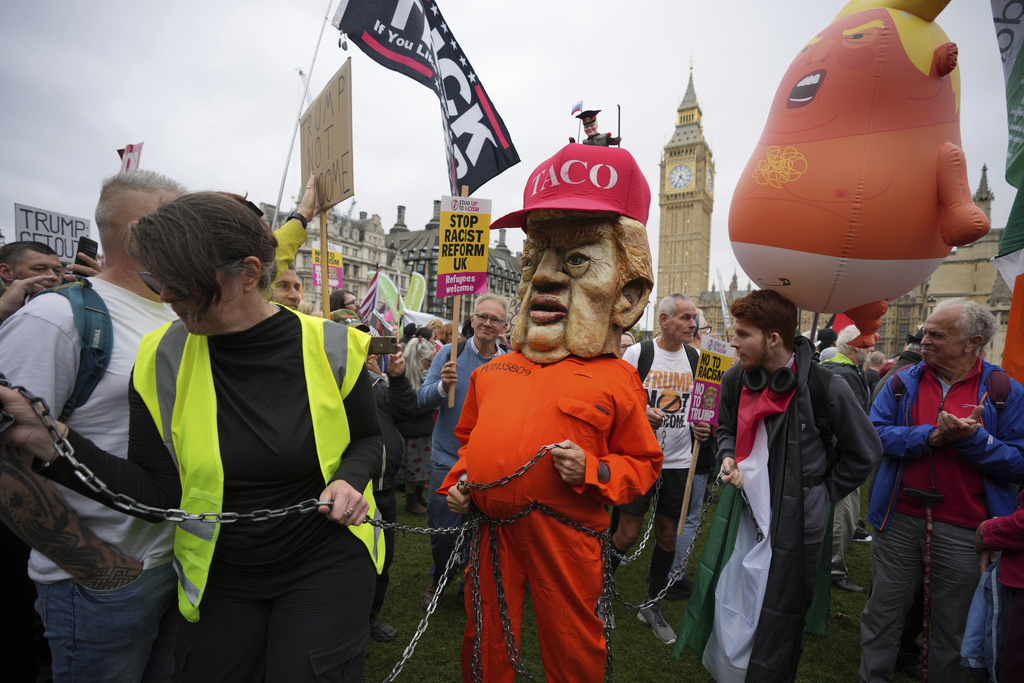 A protester wears a jail costume with a Trump mask during a demonstration of the Stop Trump Coalition group against President Donald Trump's state visit in London, Wednesday, Sept. 17, 2025.(AP Photo/Kin Cheung)