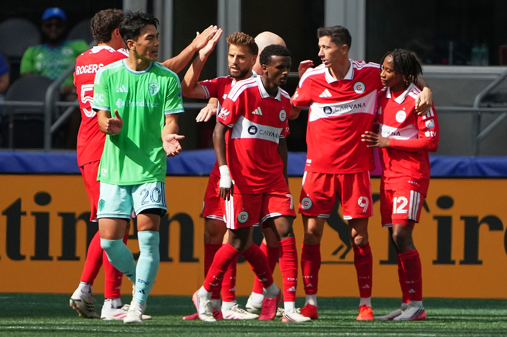 Chicago Fire FC forward Robert Lewandowski (9) celebrates his goal with teammates, including forward Puso Dithejane (12), during the second half of an MLS soccer match against the Seattle Sounders, Saturday, Aug. 29, 2026, in Seattle. (AP Photo/Lindsey Wasson)