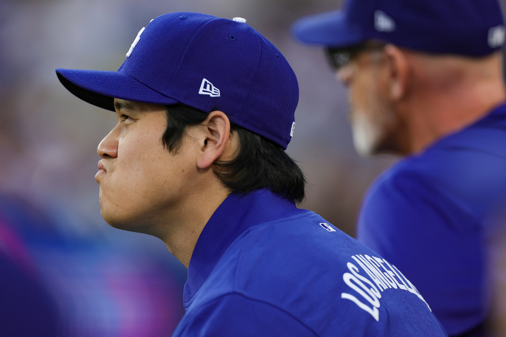 Los Angeles Dodgers pitcher Shohei Ohtani sits in the dugout during the first inning of a baseball game against the San Francisco Giants, Thursday, May 14, 2026, in Los Angeles. (AP Photo/Ryan Sun)
