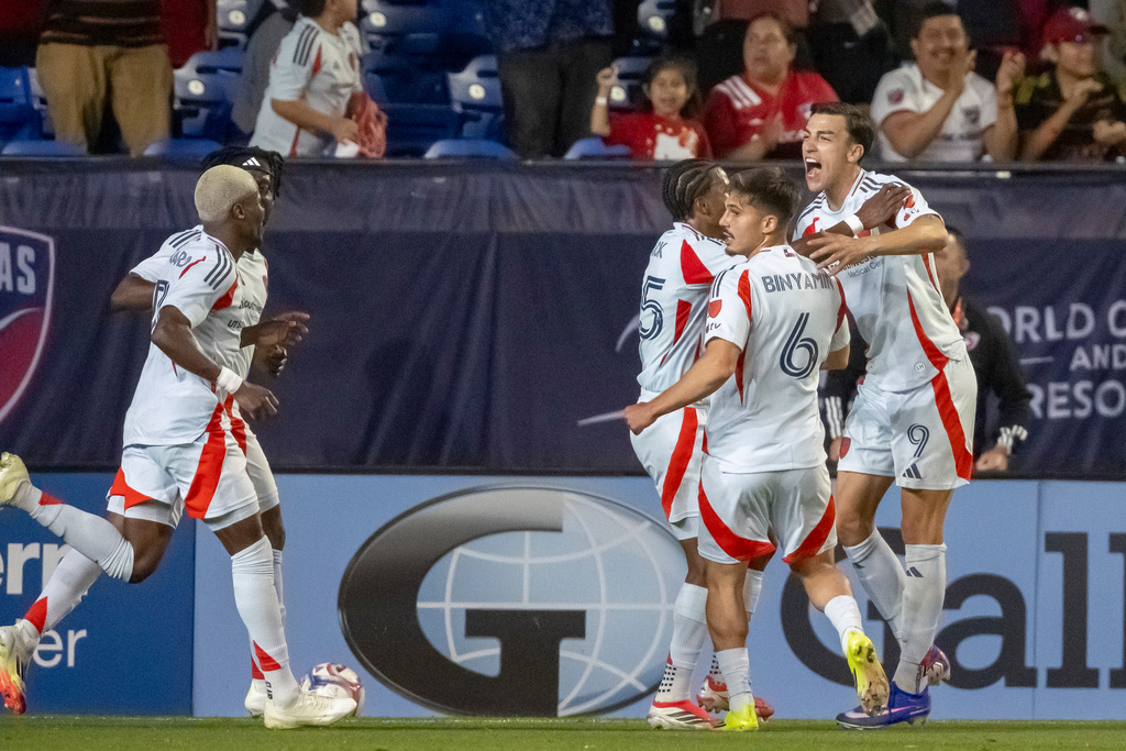 FC Dallas' Petar Musa (9) is congratulated by teammates after scoring his third goal, tying the game, during an MLS soccer match, Saturday, March 14, 2026, in Frisco, Texas. (AP Photo/Brandon Wade)