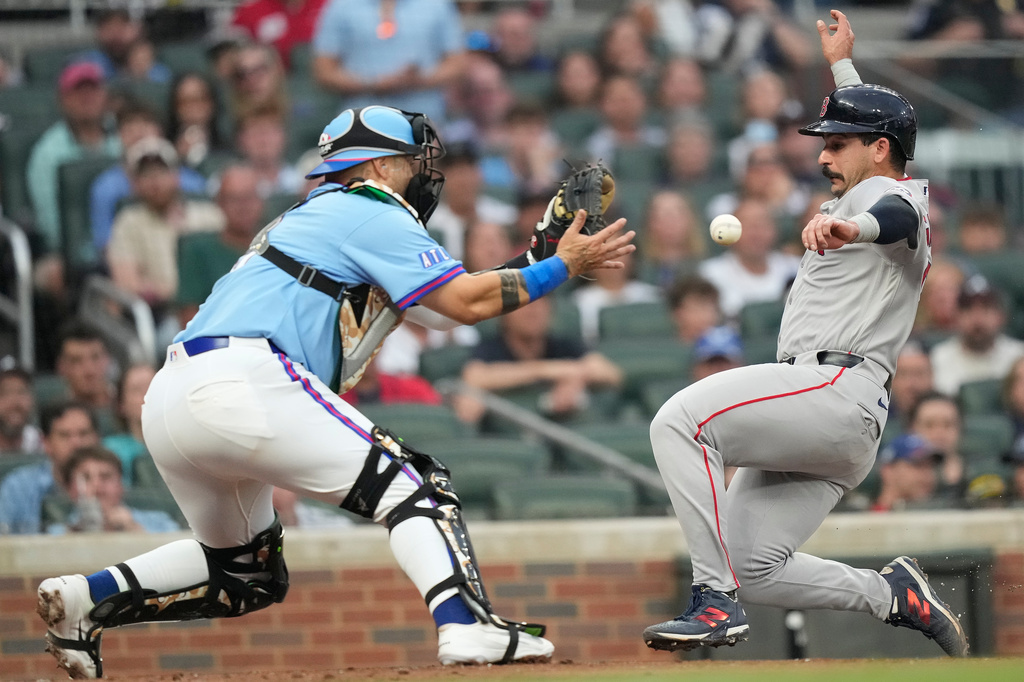 Boston Red Sox Mickey Gasper (30) slides safely into home against Atlanta Braves catcher Sandy León in the fourth inning of a baseball game Saturday, May 16, 2026, in Atlanta. (AP Photo/Brynn Anderson)
