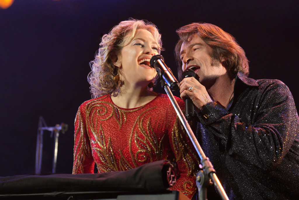 This image released by Focus Features shows Kate Hudson, left, and Hugh Jackman in a scene from "Song Sung Blue." (Sarah Shatz/Focus Features via AP)