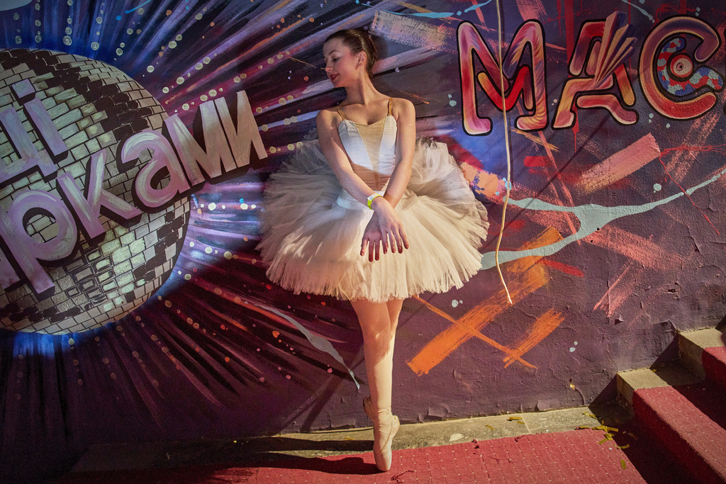 A ballet dancer warms up during the shooting of the Christmas TV show ''Dancing with the Stars'' during blackout hours caused by Russia's regular air attacks on the country's energy objects in Kyiv, Ukraine, Thursday, Dec. 18, 2025. (AP Photo/Efrem Lukatsky)