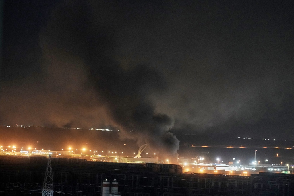 Smoke rises after an explosion at the airport in Irbil, Iraq, late Wednesday, March 11, 2026. (AP Photo/Leo Correa)
