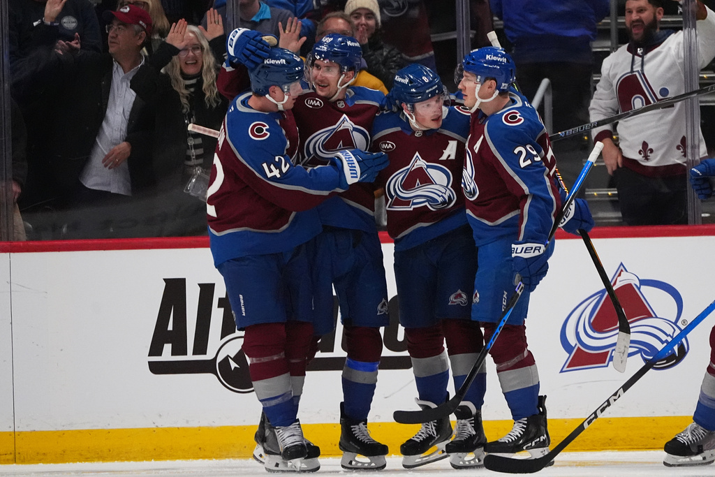 Colorado Avalanche defenseman Cale Makar, third from left, is congratulated after scoring by, from left to right, defenseman Josh Manson, center Martin Necas and center Nathan MacKinnon in the second period of an NHL hockey game against the Ottawa Senators, Thursday, Jan. 8, 2026, in Denver. (AP Photo/David Zalubowski)