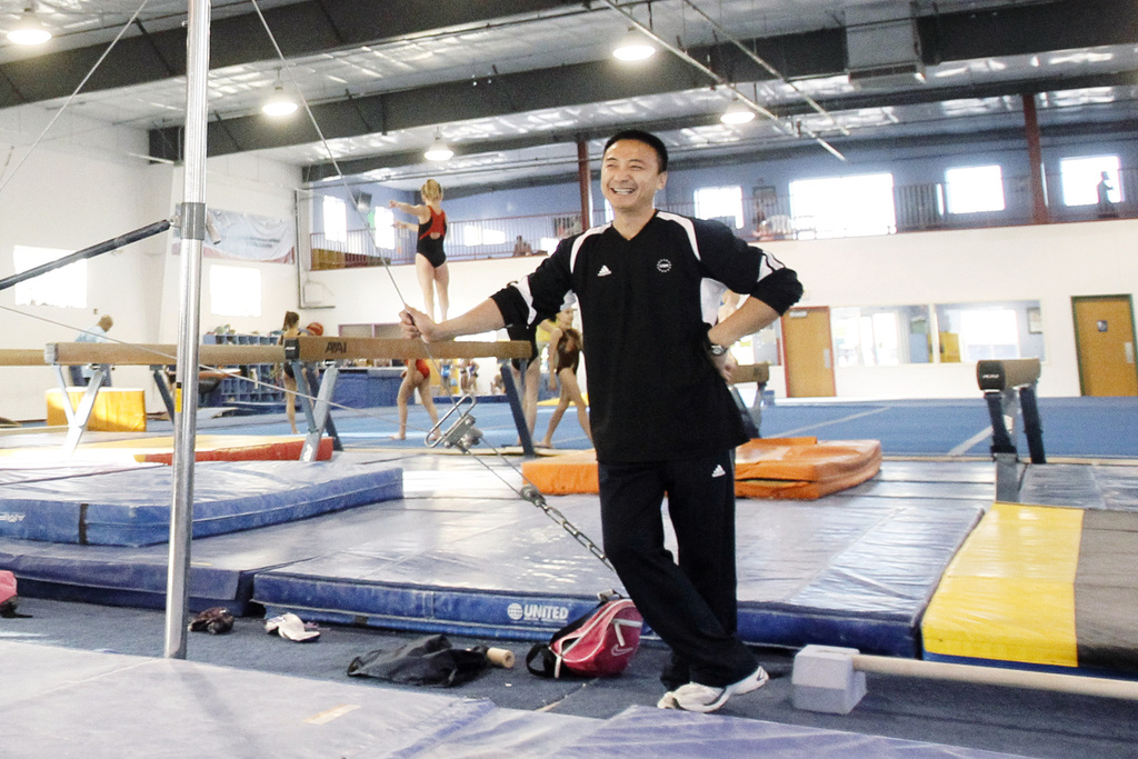 FILE - Coach Liang "Chow" Qiao is seen during a workout at Chow's Gymnastics on Nov. 15, 2010, in West Des Moines, Iowa. (AP Photo/Charlie Neibergall)