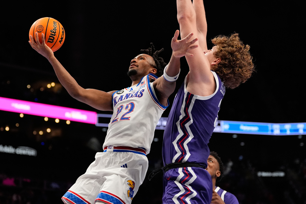 Kansas' Darryn Peterson (22) heads to the basket past TCU's Liutauras Lelevicius during the second half of an NCAA college basketball game in the quarterfinal round of the Big 12 Conference tournament Thursday, March 12, 2026, in Kansas City, Mo. (AP Photo/Charlie Riedel)