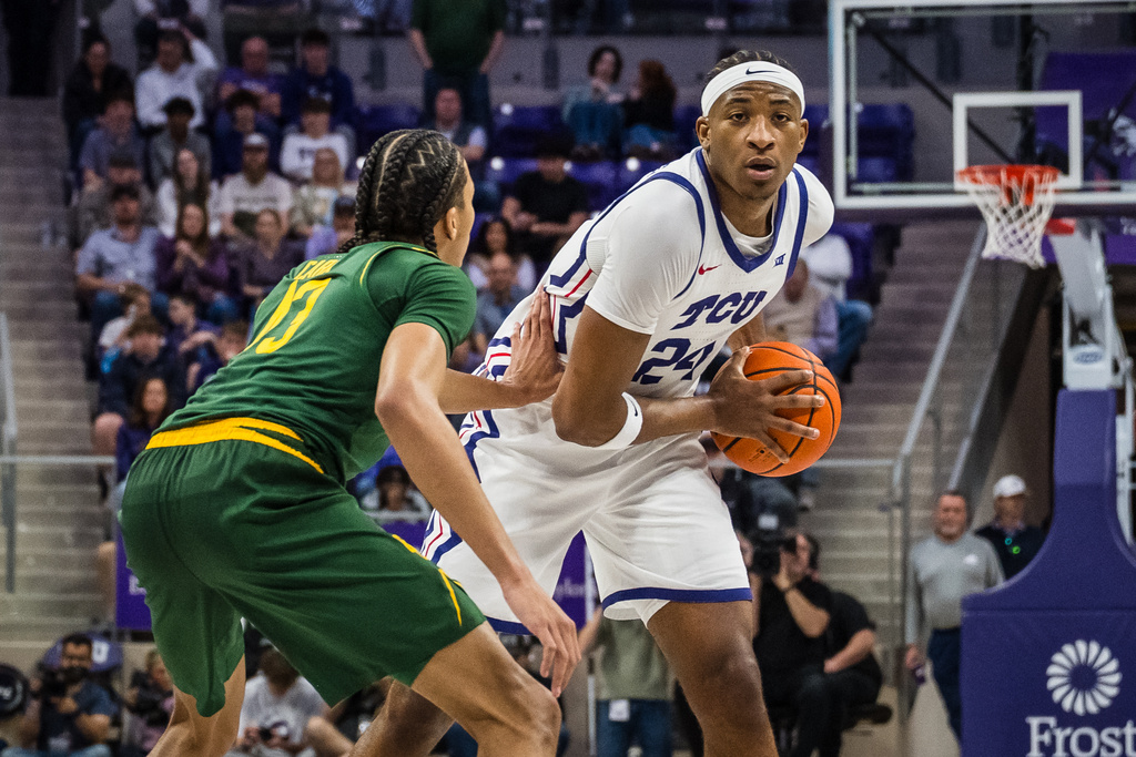TCU forward Xavier Edmonds (24) looks to pass the ball during an NCAA college basketball game against Baylor, Saturday, Jan. 3, 2026, Fort Worth, Texas. (AP Photo/Jessica Tobias)