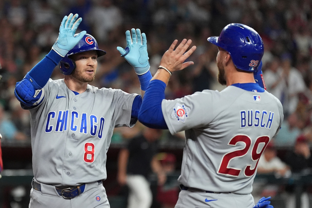 Chicago Cubs' Ian Happ (8) celebrates his three-run home run against the Arizona Diamondbacks with Cubs' Michael Busch (29) during the fourth inning of a baseball game, Tuesday, Aug. 25, 2026, in Phoenix. (AP Photo/Ross D. Franklin)