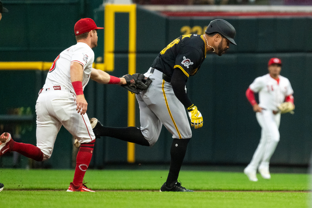 Cincinnati Reds second base Matt McLain tags out Pittsburgh Pirates' Tommy Pham while attempting to steal second base in the second inning of a baseball game, Wednesday, Sept. 24, 2025, in Cincinnati. (AP Photo/Michael Swensen)