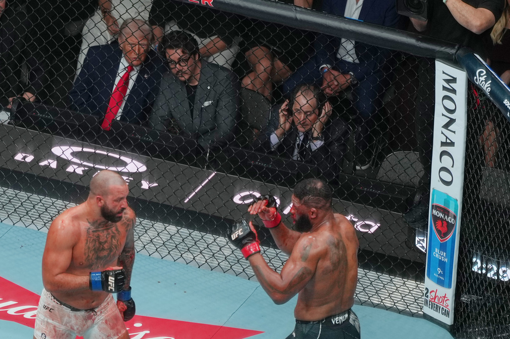 President Donald Trump and Hunter Campbell watch a fight during UFC 327 at Kaseya Center, Saturday, April 11, 2026, in Miami. (AP Photo/Julia Demaree Nikhinson)