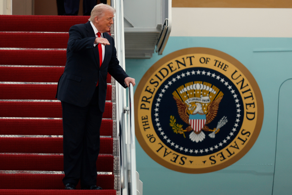 President Donald Trump gestures toward the media as he walks down the stairs of Air Force One upon his arrival at Joint Base Andrews, Md., Sunday, Nov. 9, 2025, after returning from his Mar-a-Lago estate in Palm Beach, Fla. and en route to an NFL football game between the Washington Commanders and the Detroit Lions. (AP Photo/Luis M. Alvarez)